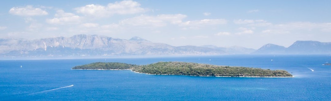 Tropical island washed by blue sea water on sunny day
